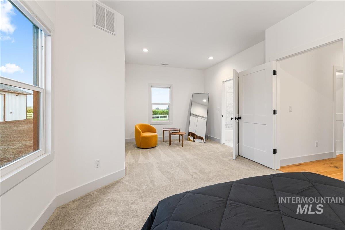 Bedroom with light colored carpet and recessed lighting