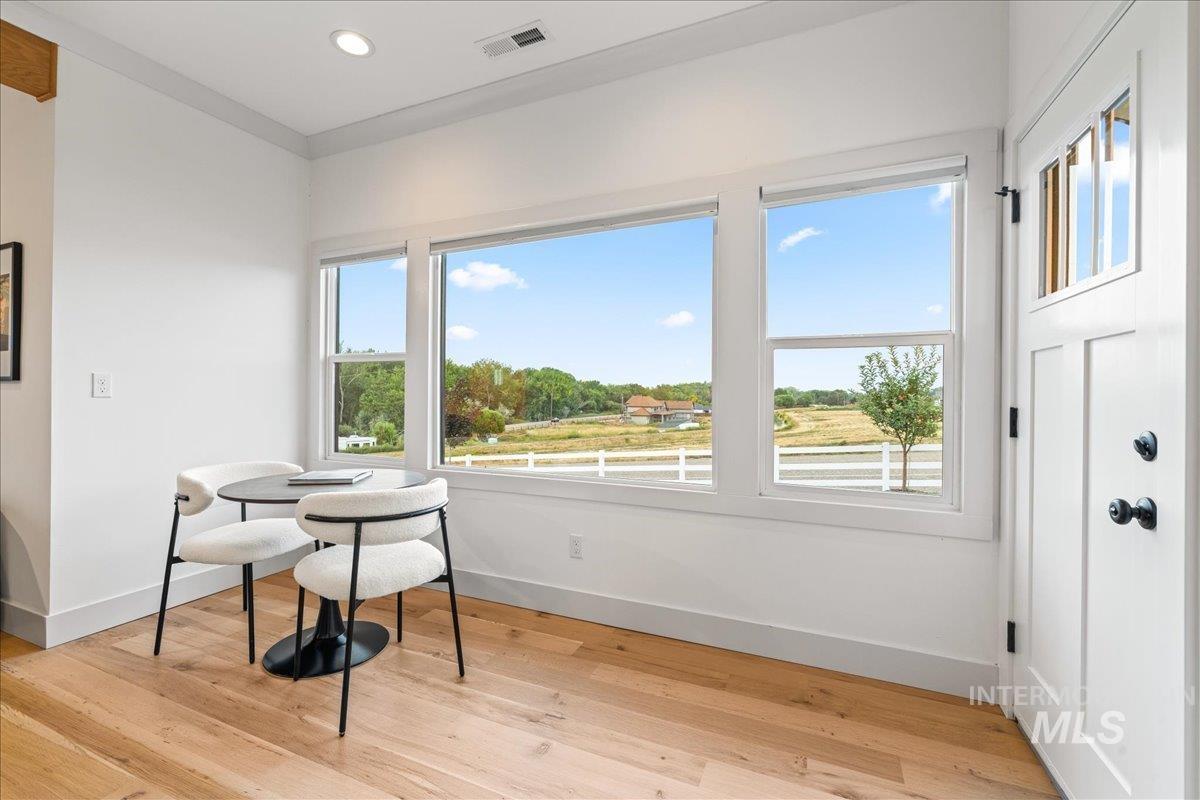 Dining space with light wood-type flooring and recessed lighting