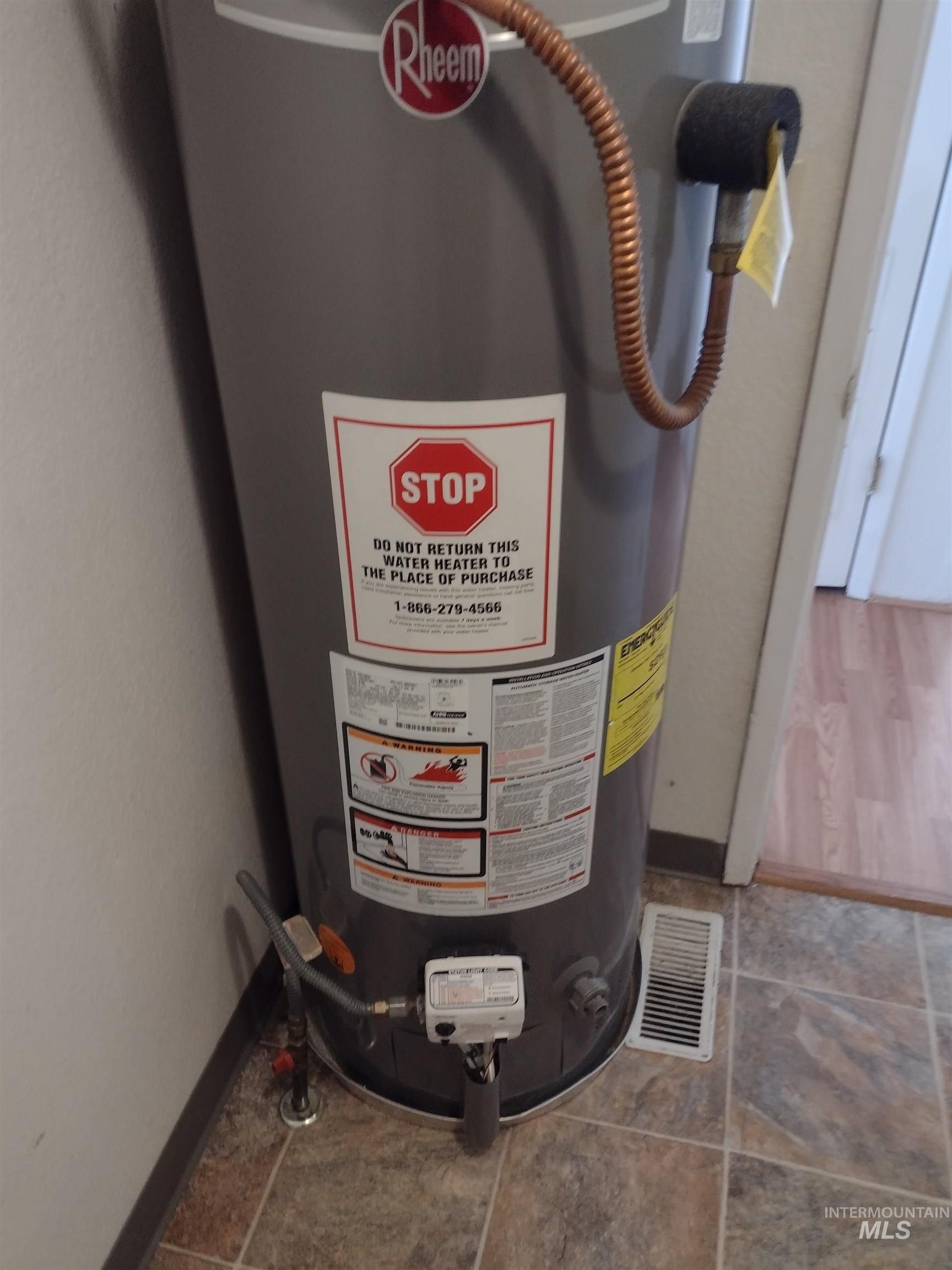 Utility room featuring gas water heater