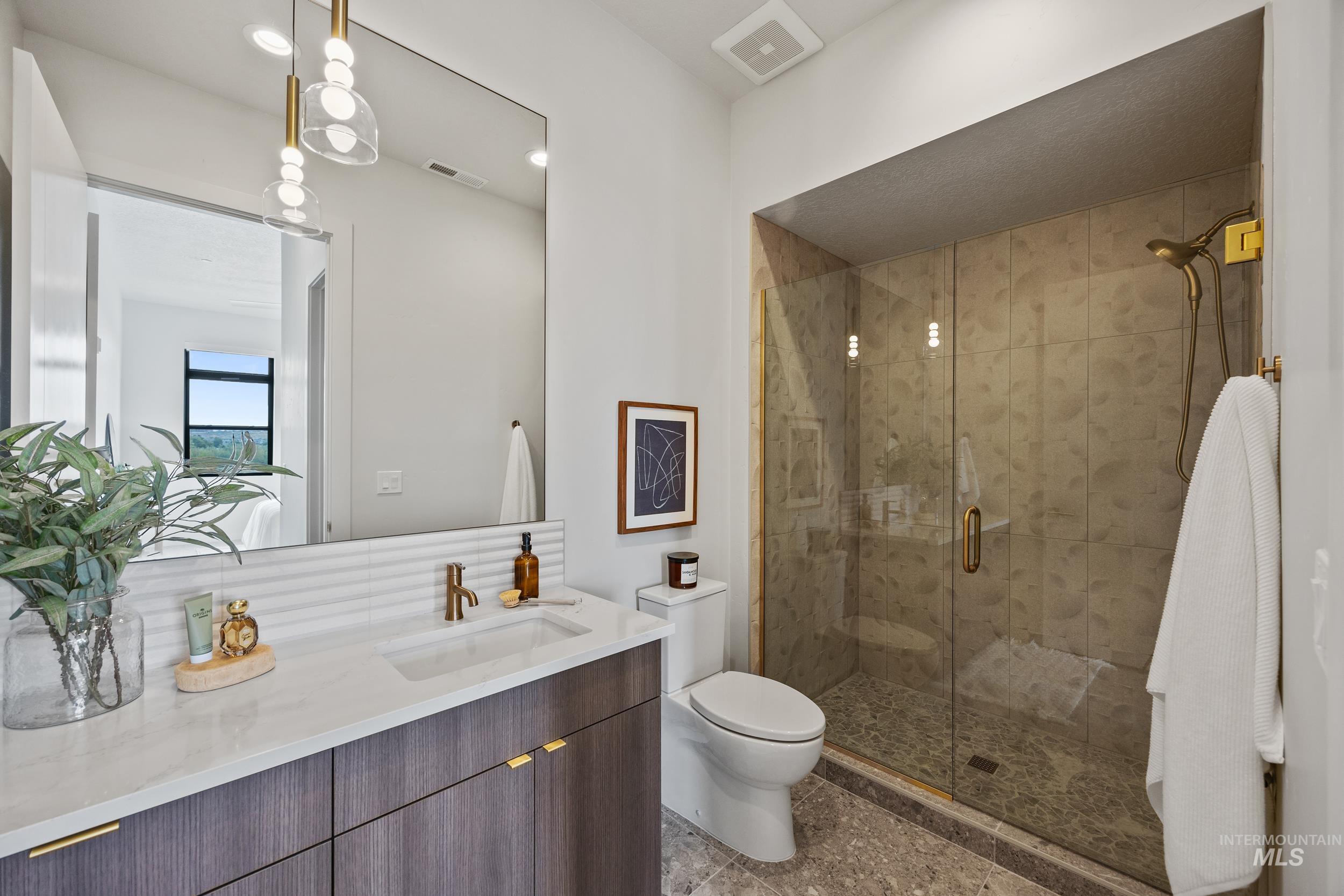 Full bathroom with vanity, a stall shower, and recessed lighting