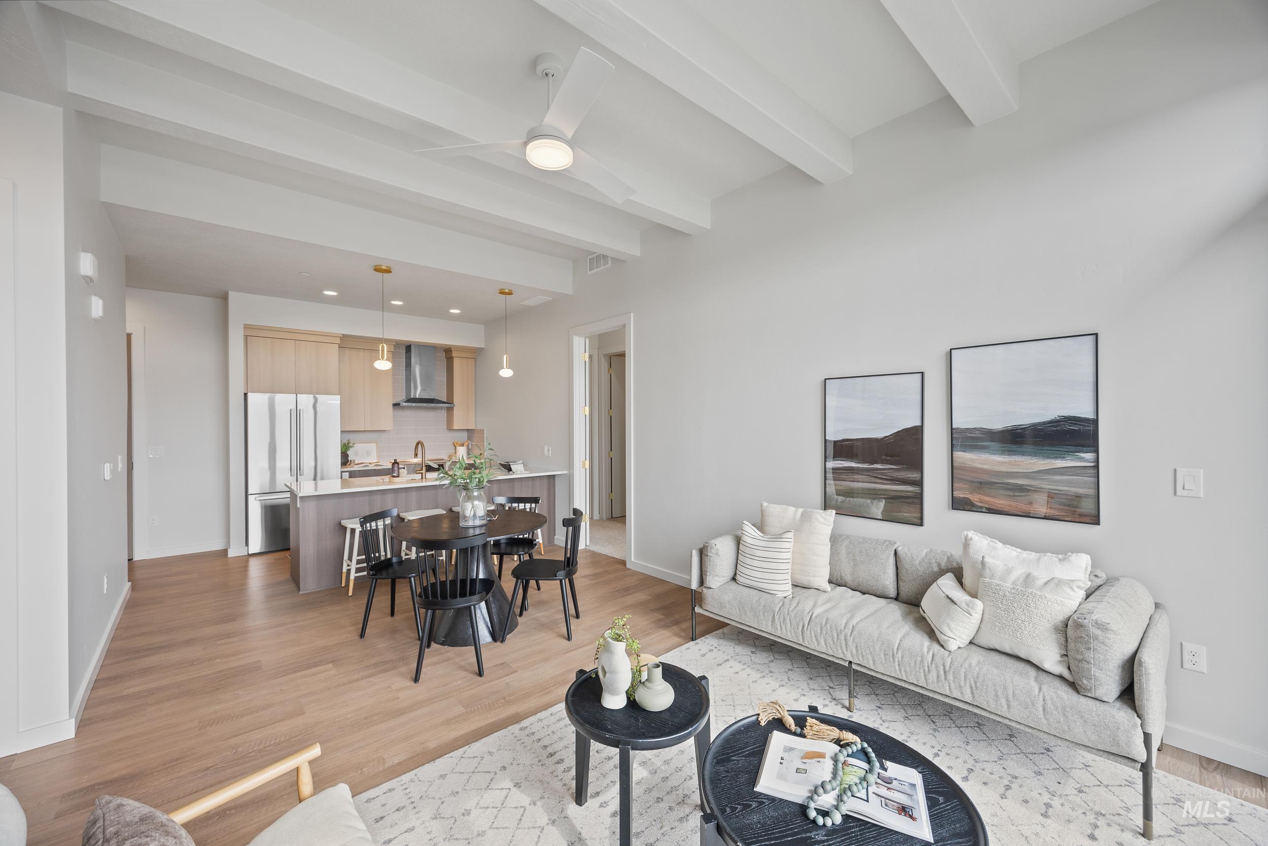 Living area with light wood finished floors, a ceiling fan, beam ceiling, and recessed lighting
