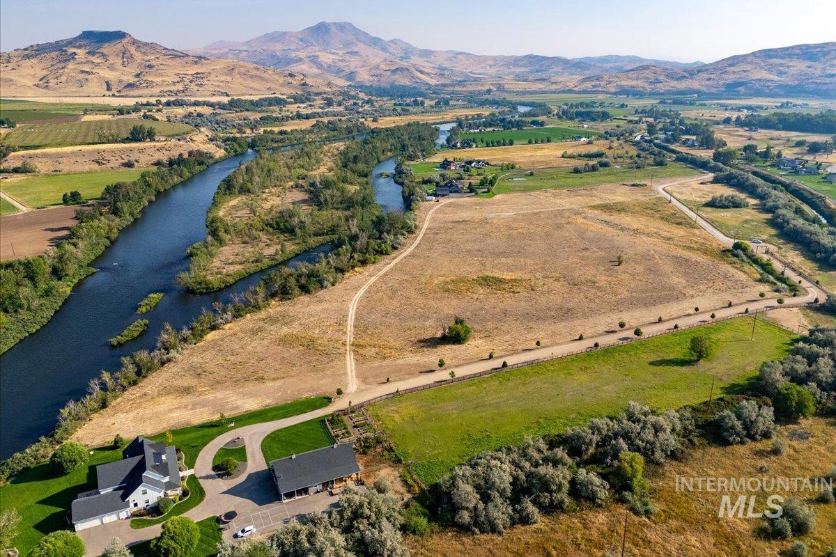 View of property location featuring rural landscape and a water and mountain view