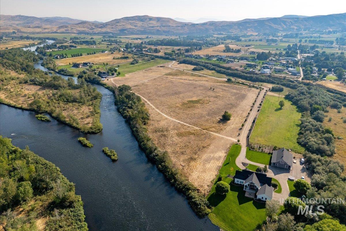 Aerial view of property's location with rural landscape and a water and mountain view