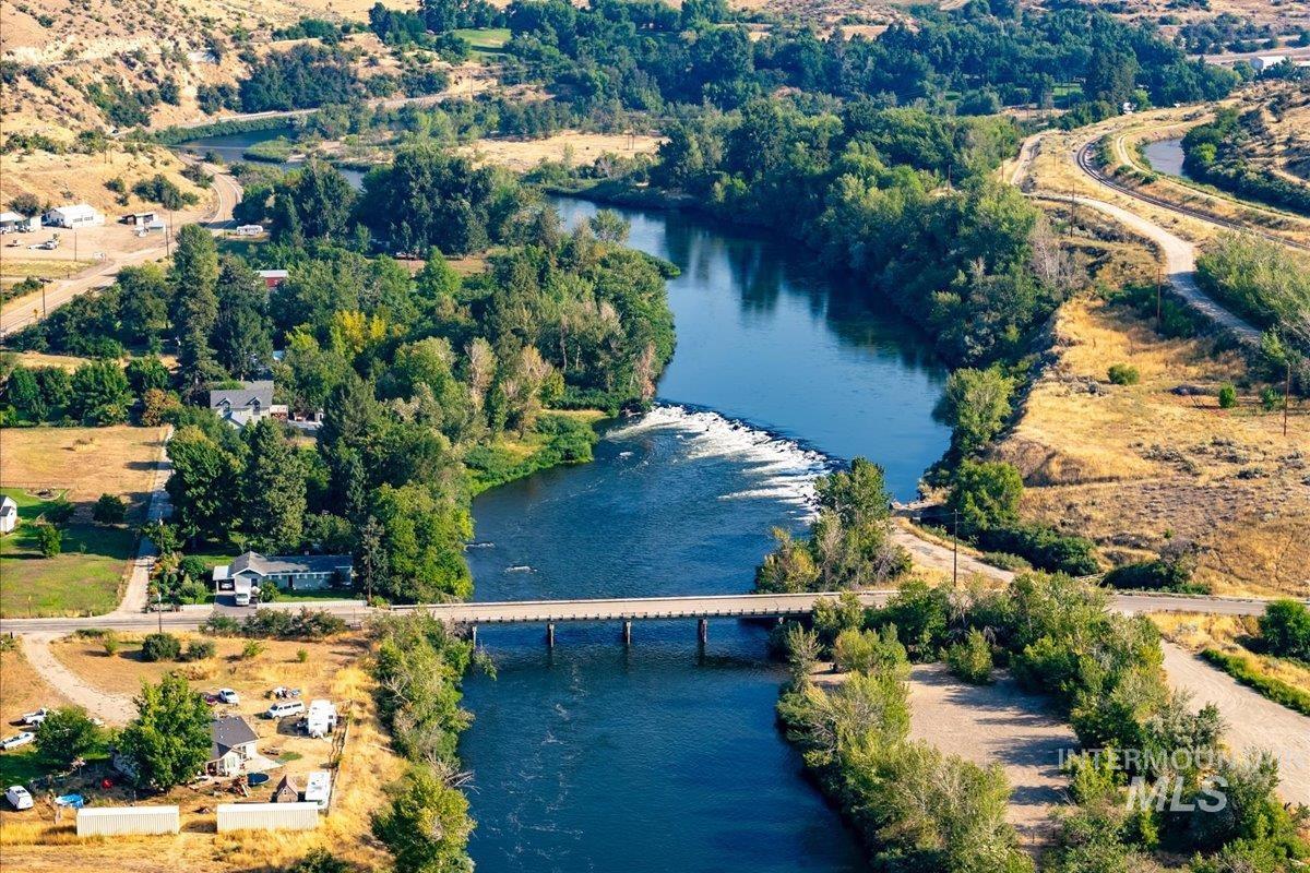 Aerial view of property and surrounding area with a nearby body of water