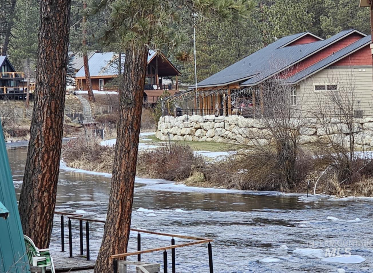 Yard layered in snow featuring a water view
