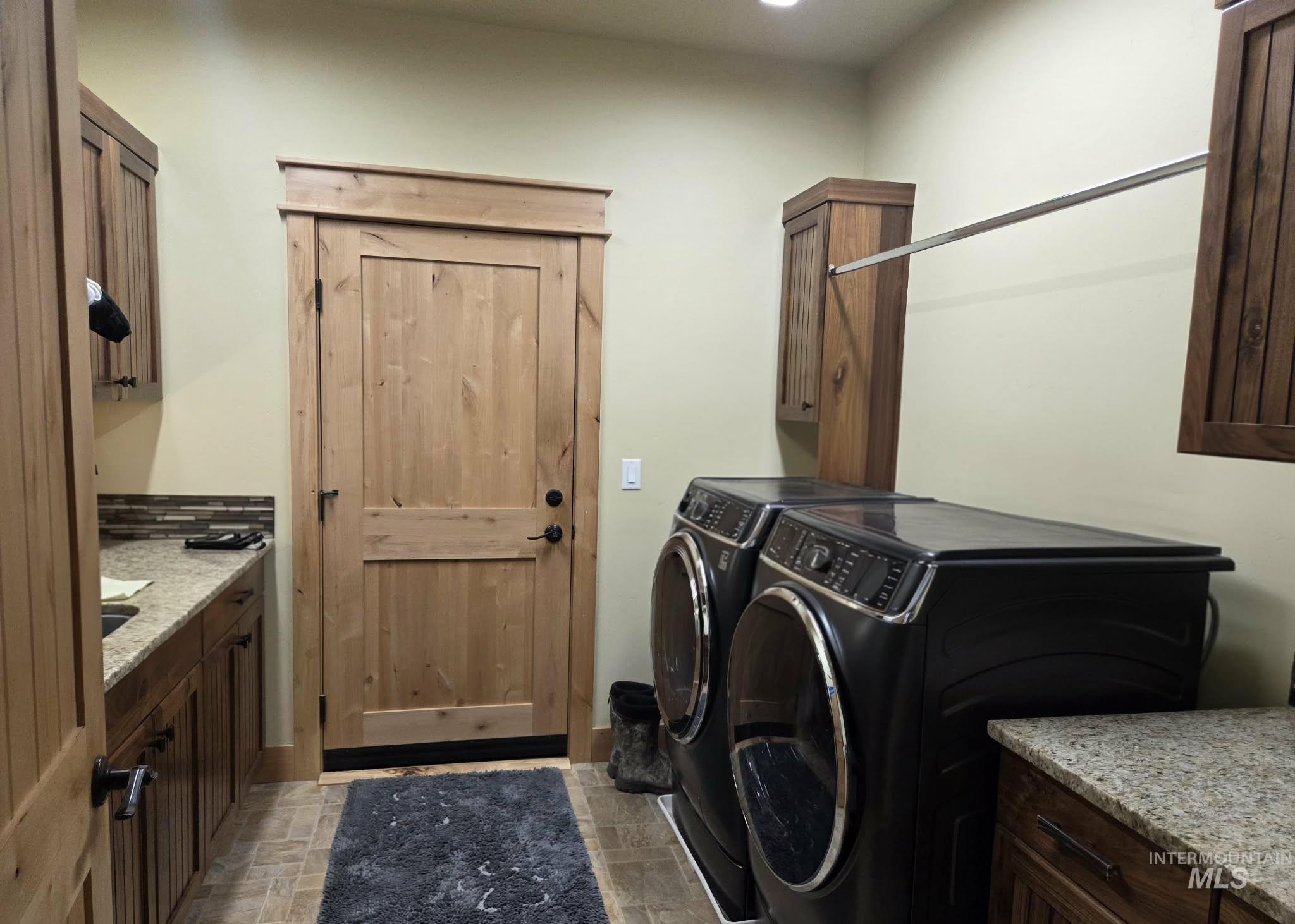 Laundry area featuring cabinet space and washing machine and dryer
