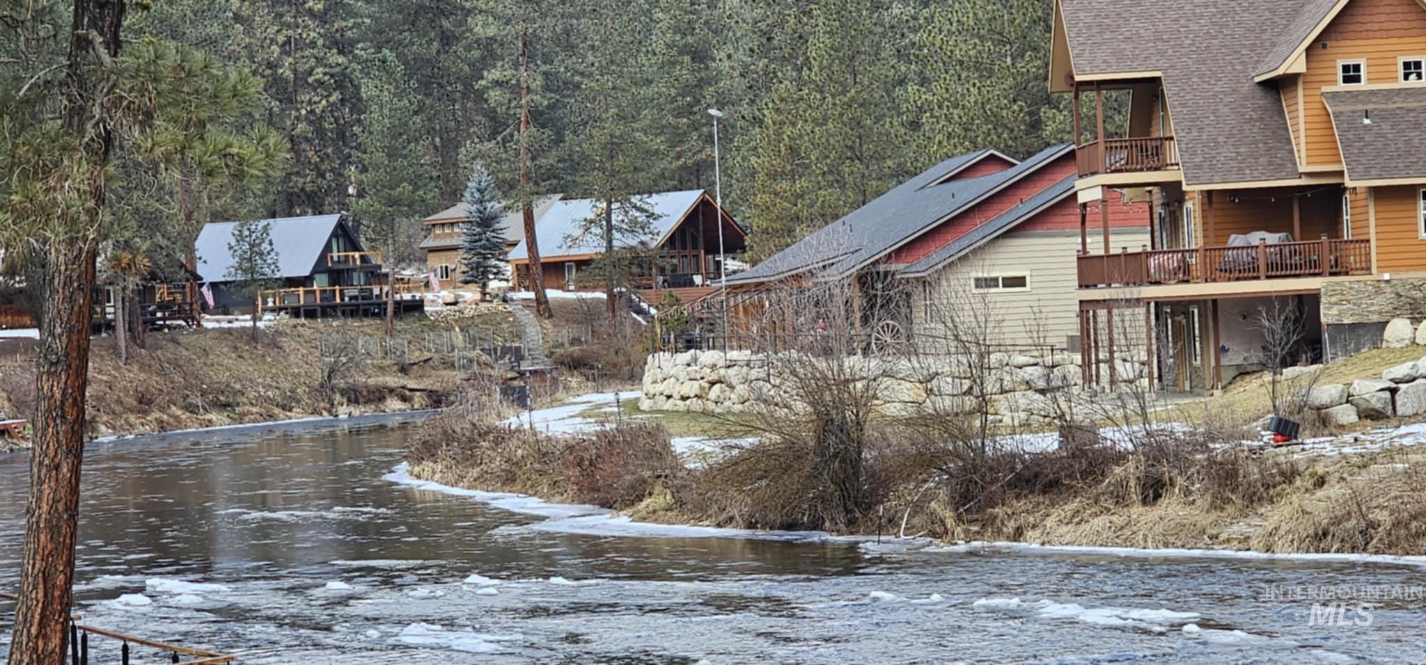 Yard covered in snow featuring a water view 2nd house