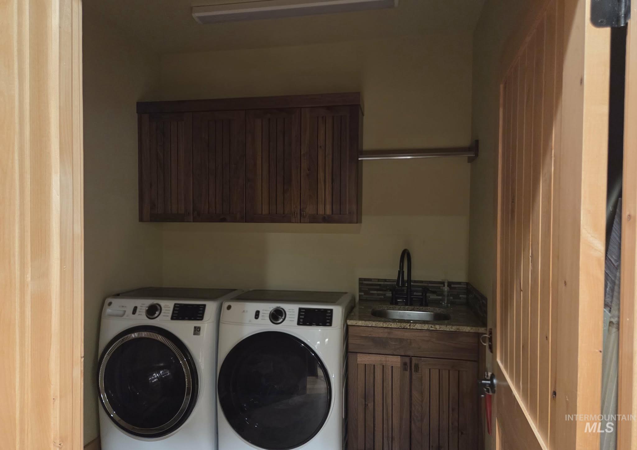 Apartment Laundry area featuring cabinet space and washer and dryer