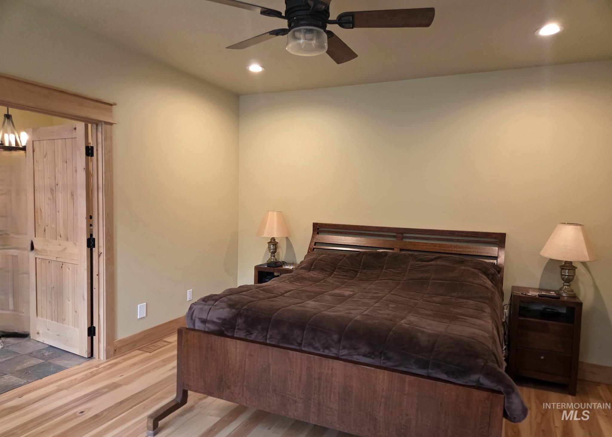 Bedroom featuring light wood-style flooring, recessed lighting, and a ceiling fan