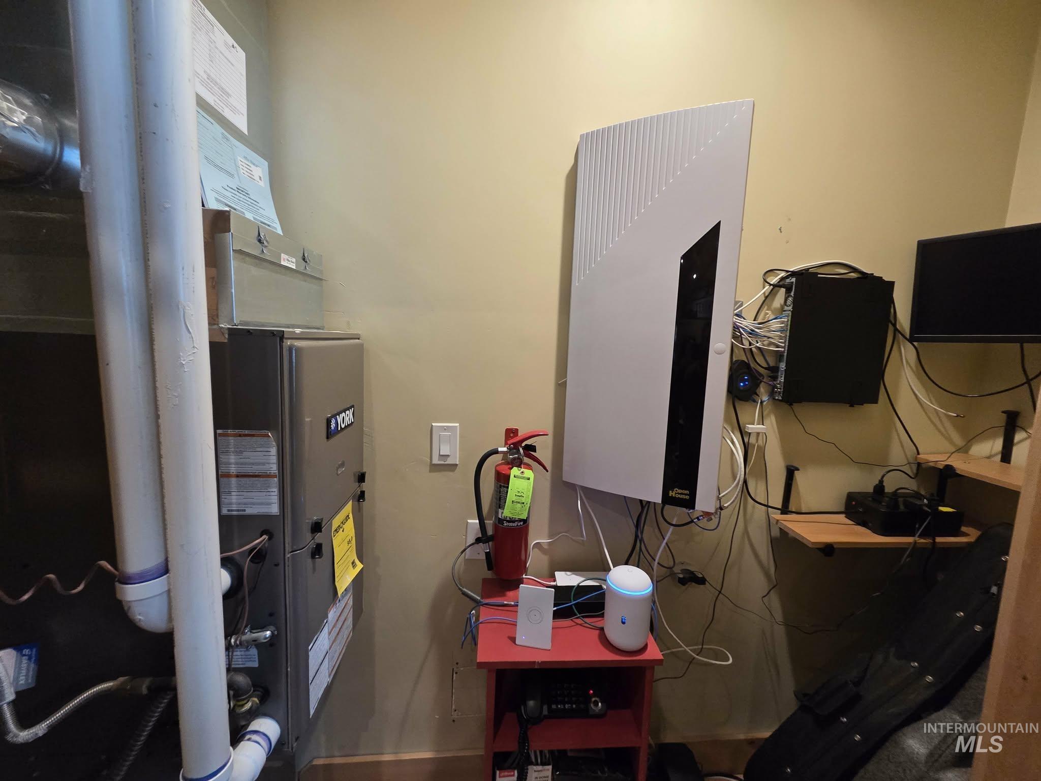 Utility room featuring heating unit