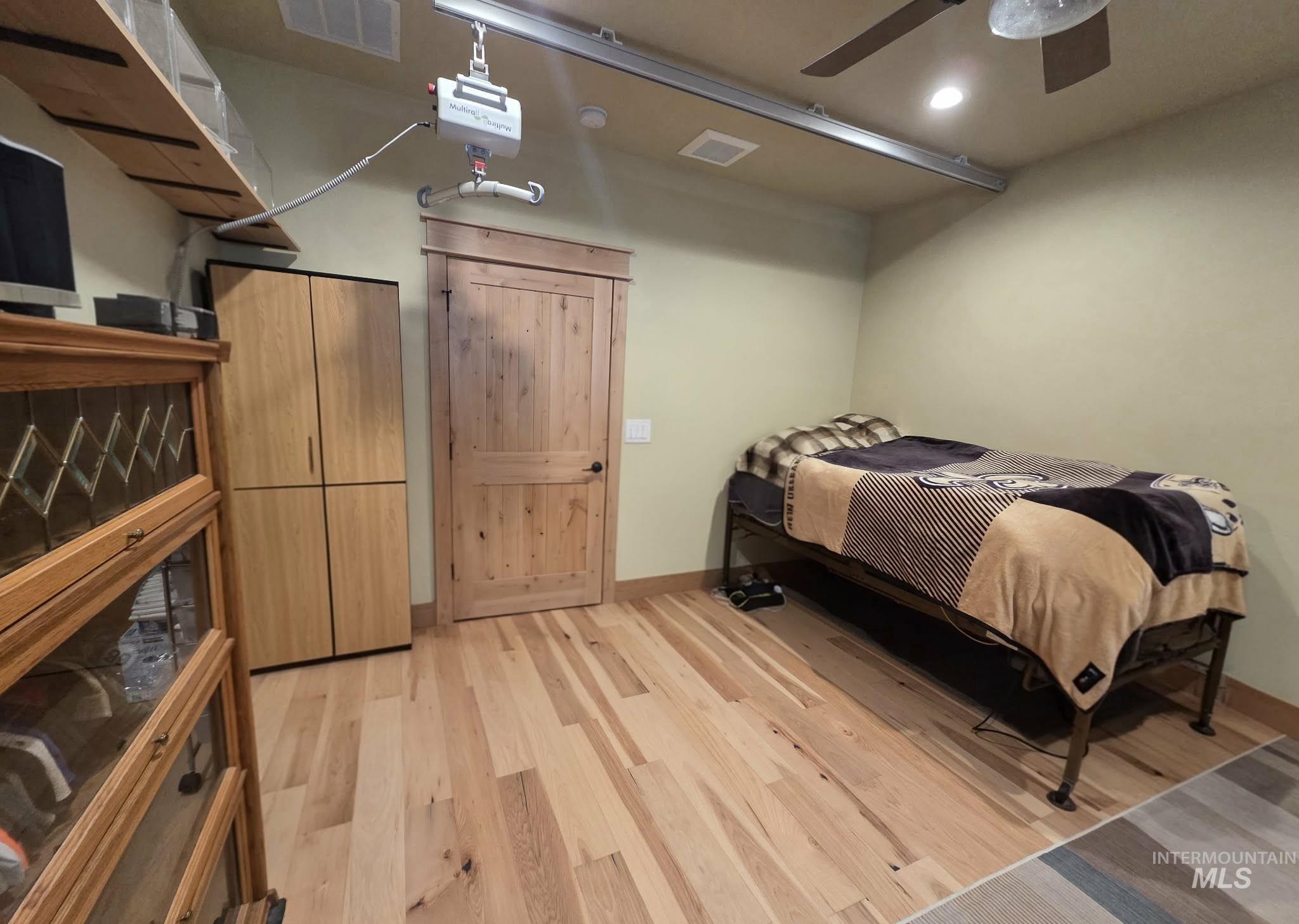 Bedroom with light wood-style flooring, a ceiling fan, and recessed lighting