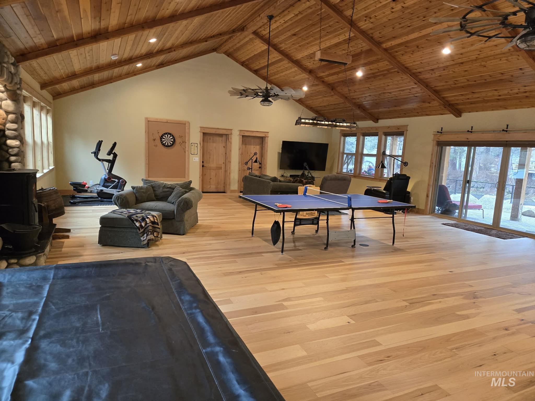 Game room featuring a ceiling fan, a high wooden beamed ceiling, light wood-type flooring, and recessed lighting