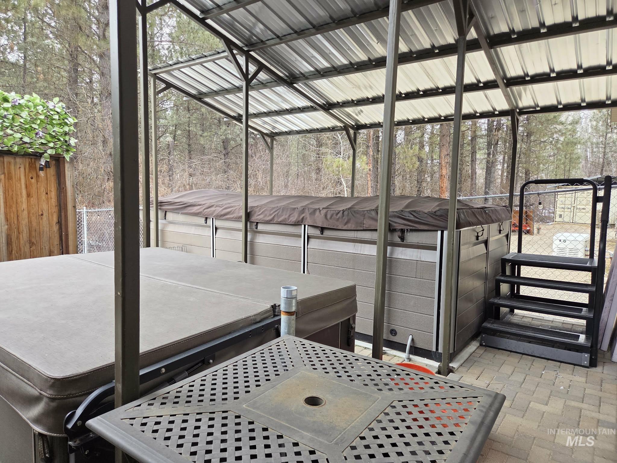 View of patio / terrace featuring a hot tub & Swimspa