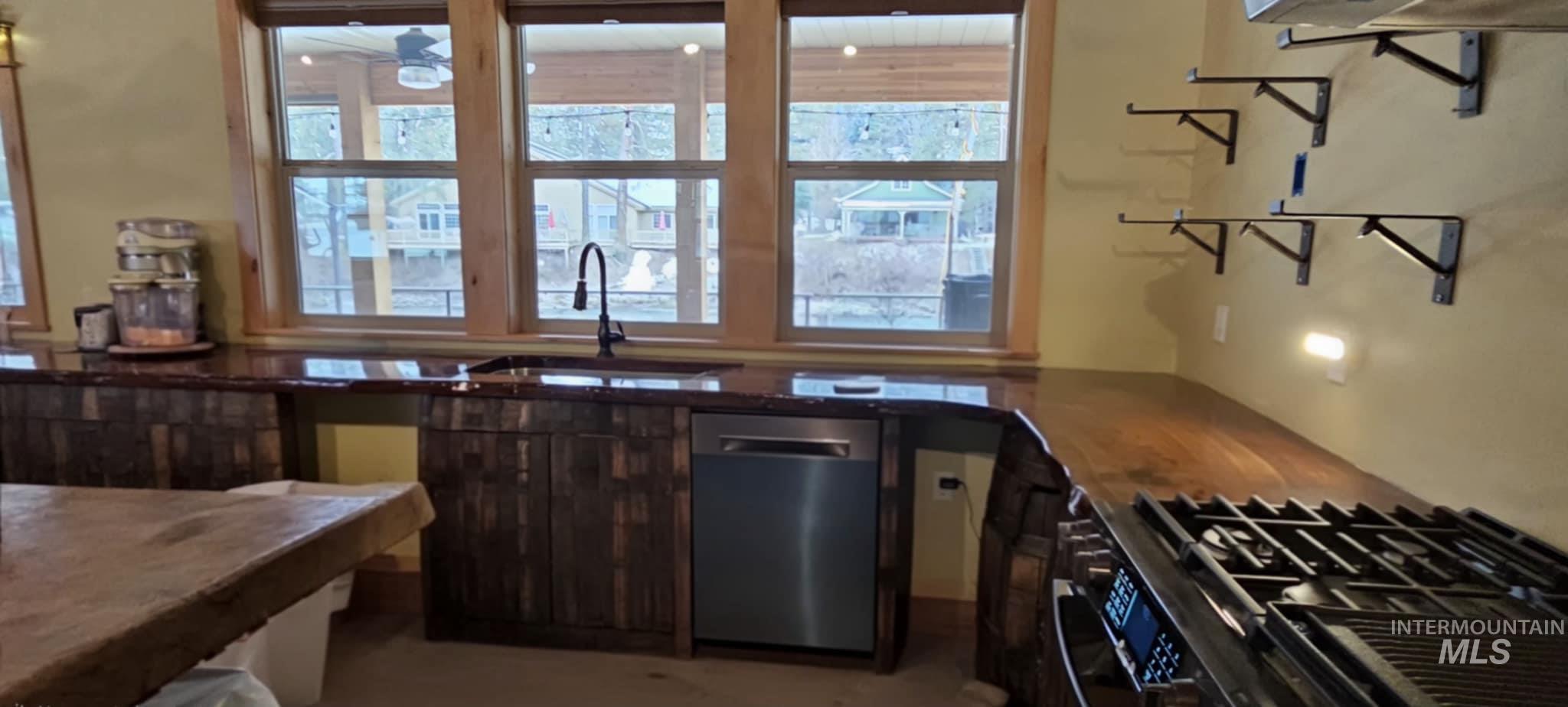 Kitchen featuring stainless steel dishwasher and gas stove
