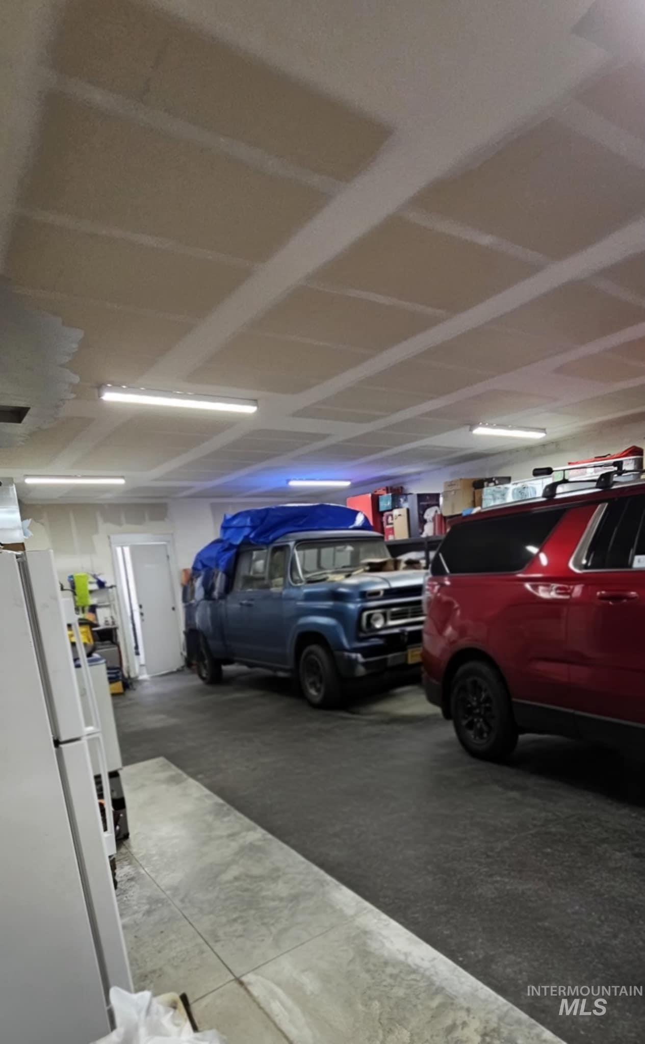Garage with freestanding refrigerator