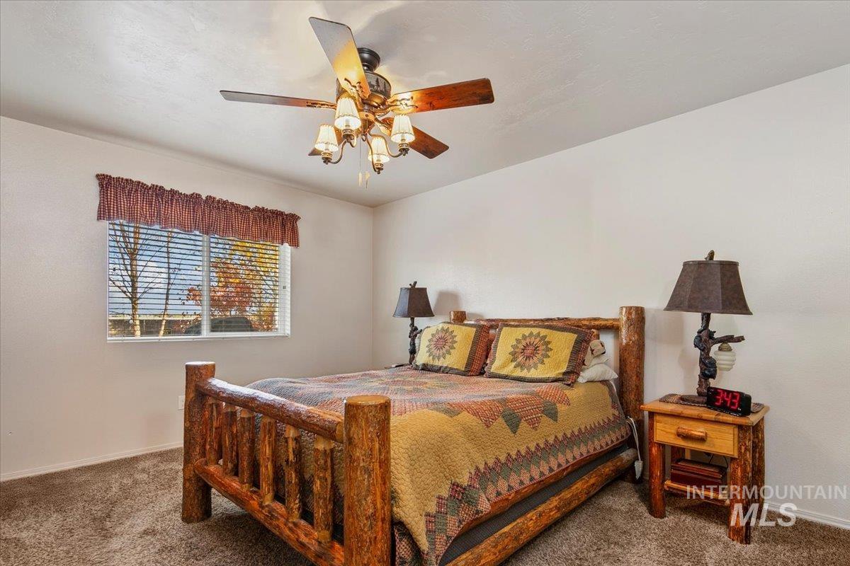 Bedroom with carpet flooring and a ceiling fan