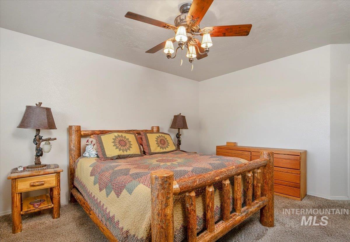 Bedroom featuring carpet and ceiling fan