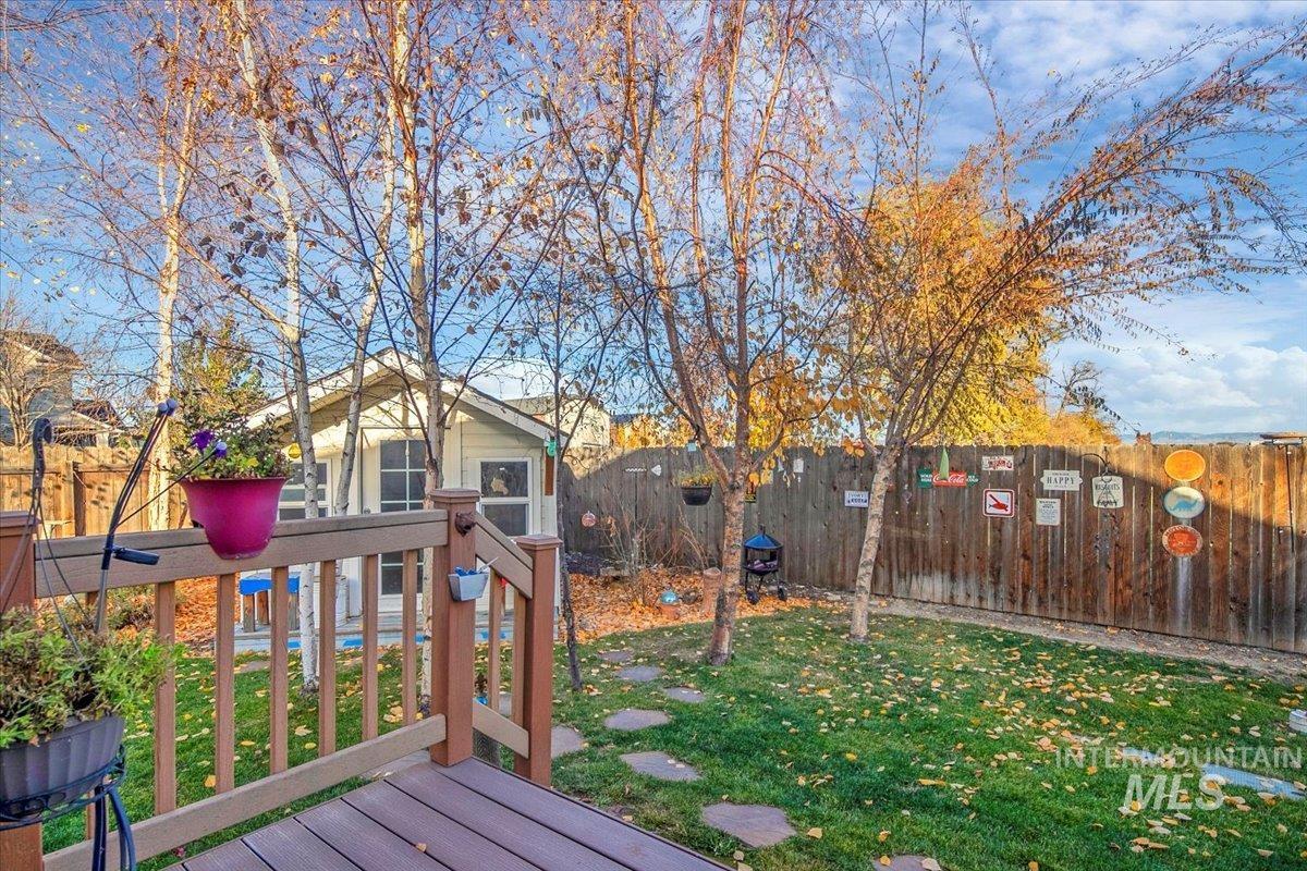 Wooden deck with a fenced backyard
