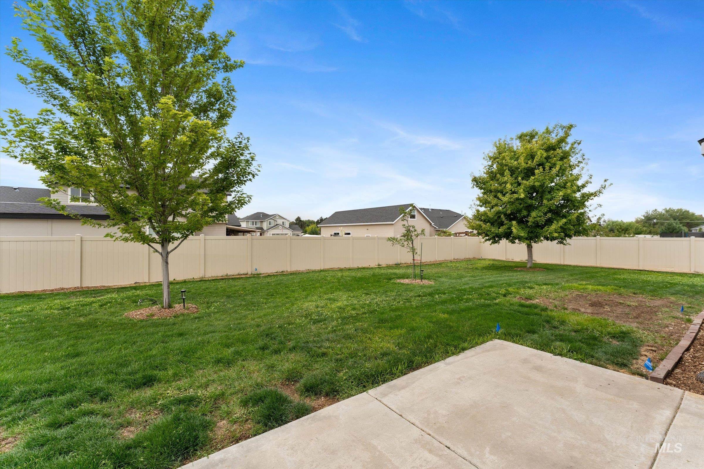 Fenced backyard with a patio area