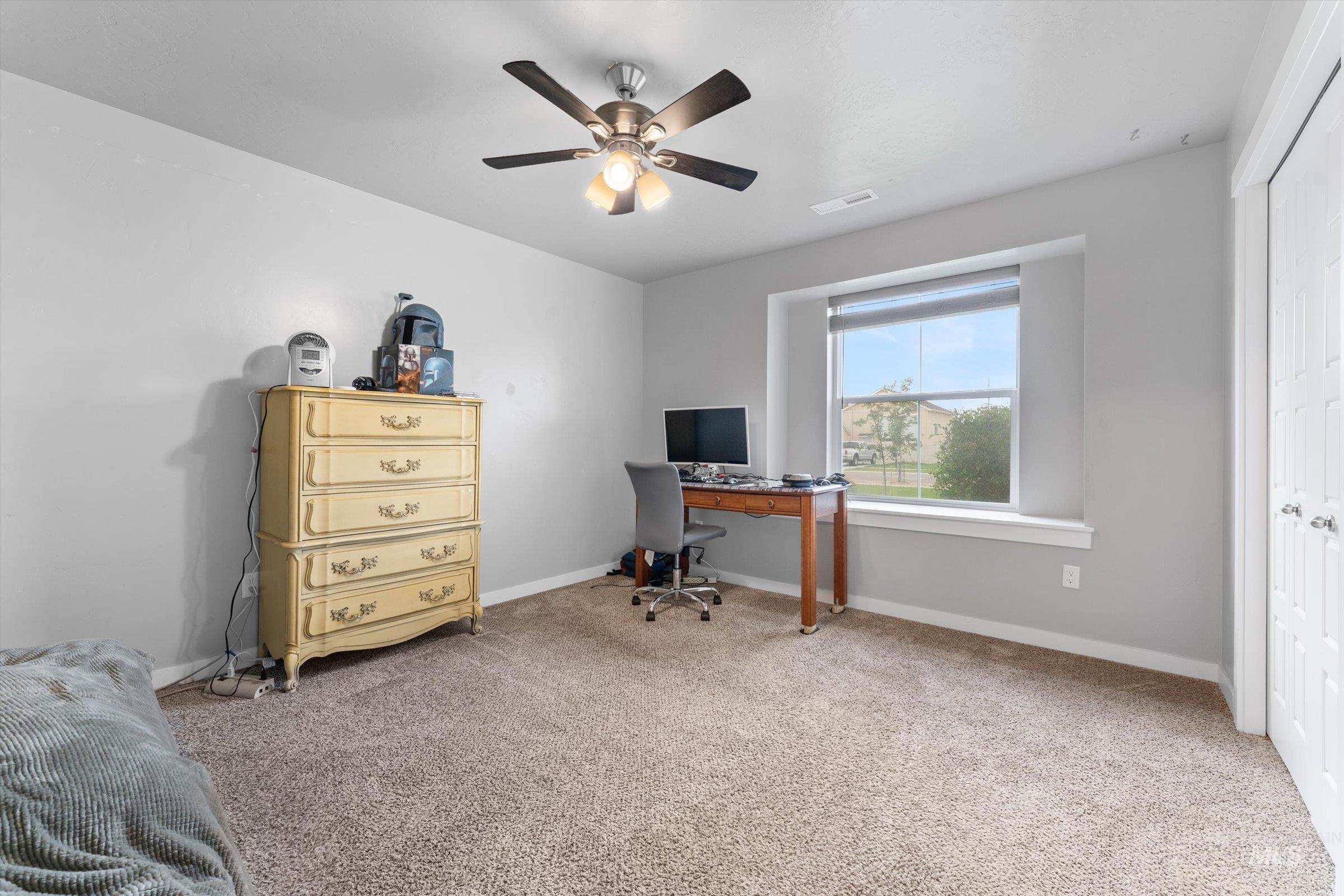 Office featuring light colored carpet and a ceiling fan