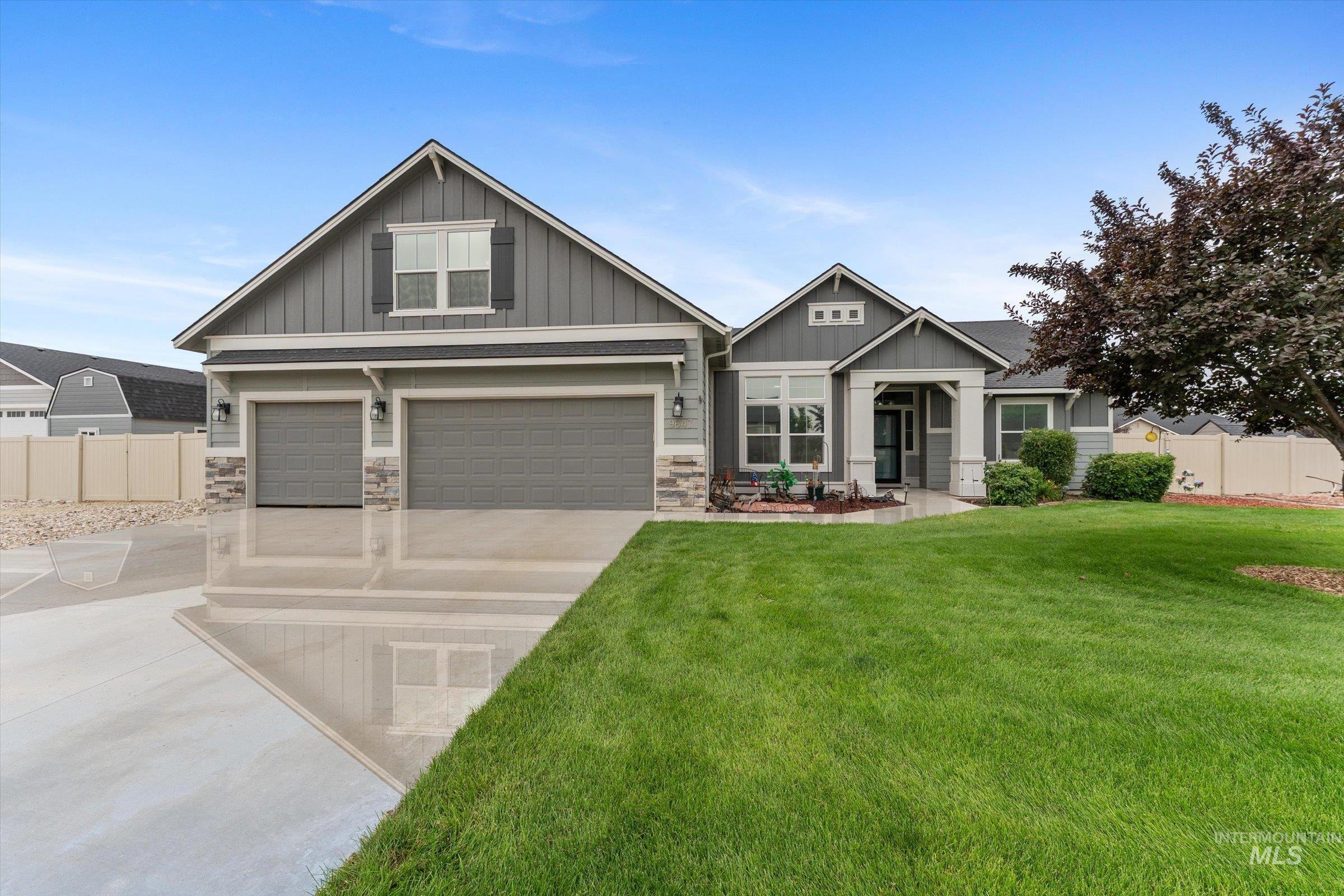Craftsman-style home with board and batten siding, driveway, and an attached garage