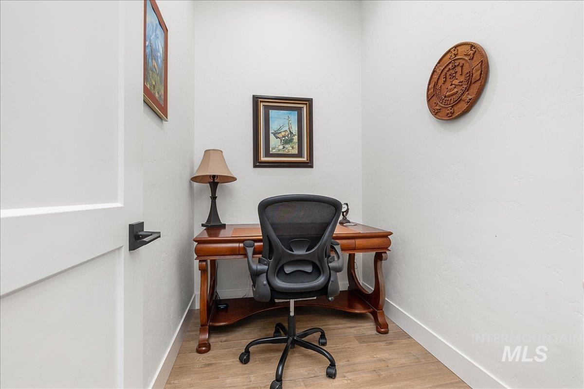 Office space featuring light wood-style floors and baseboards
