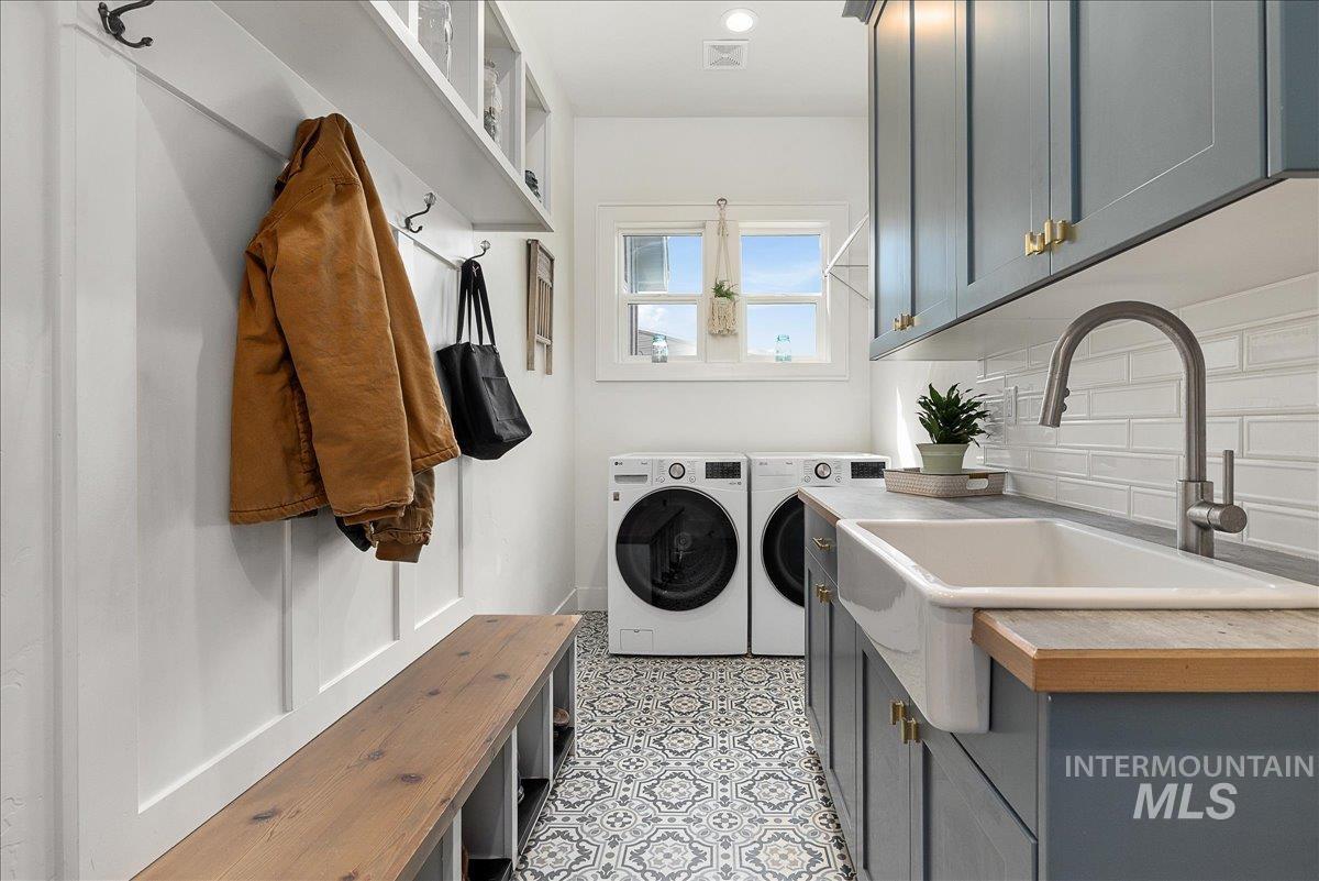 Washroom featuring washer and dryer, cabinet space, and recessed lighting