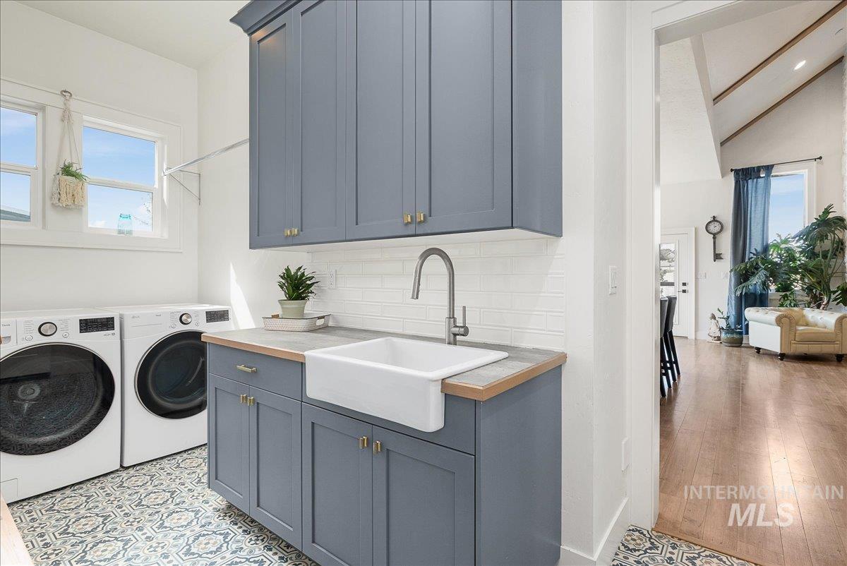 Laundry area featuring washer and dryer and cabinet space
