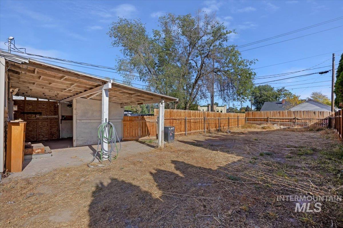 View of yard with a patio, an outdoor structure, and an exterior structure