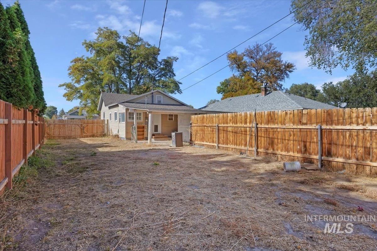 Back of property with a patio area and a fenced backyard