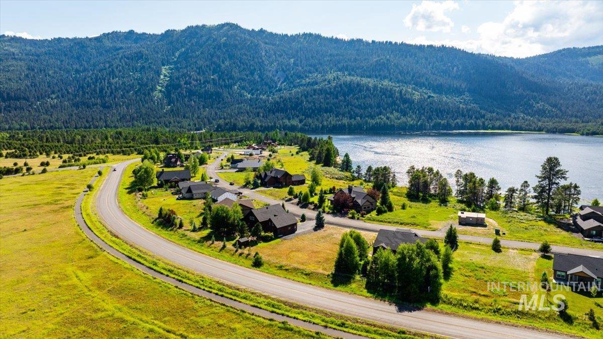 Bird's eye view of a heavily wooded area and a water and mountain view