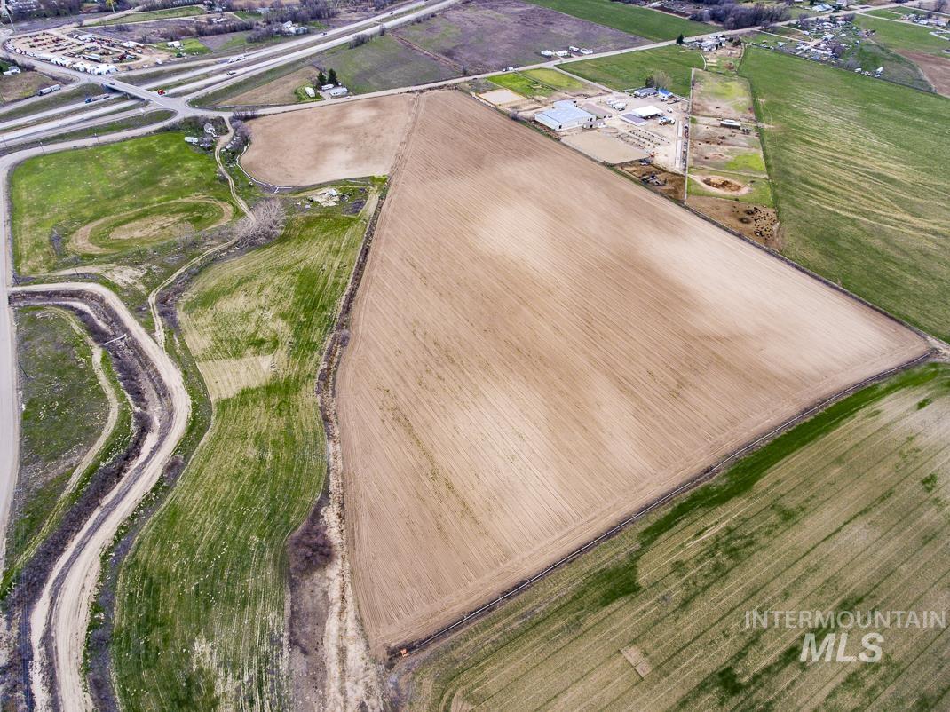 Aerial view of property and surrounding area featuring rural landscape
