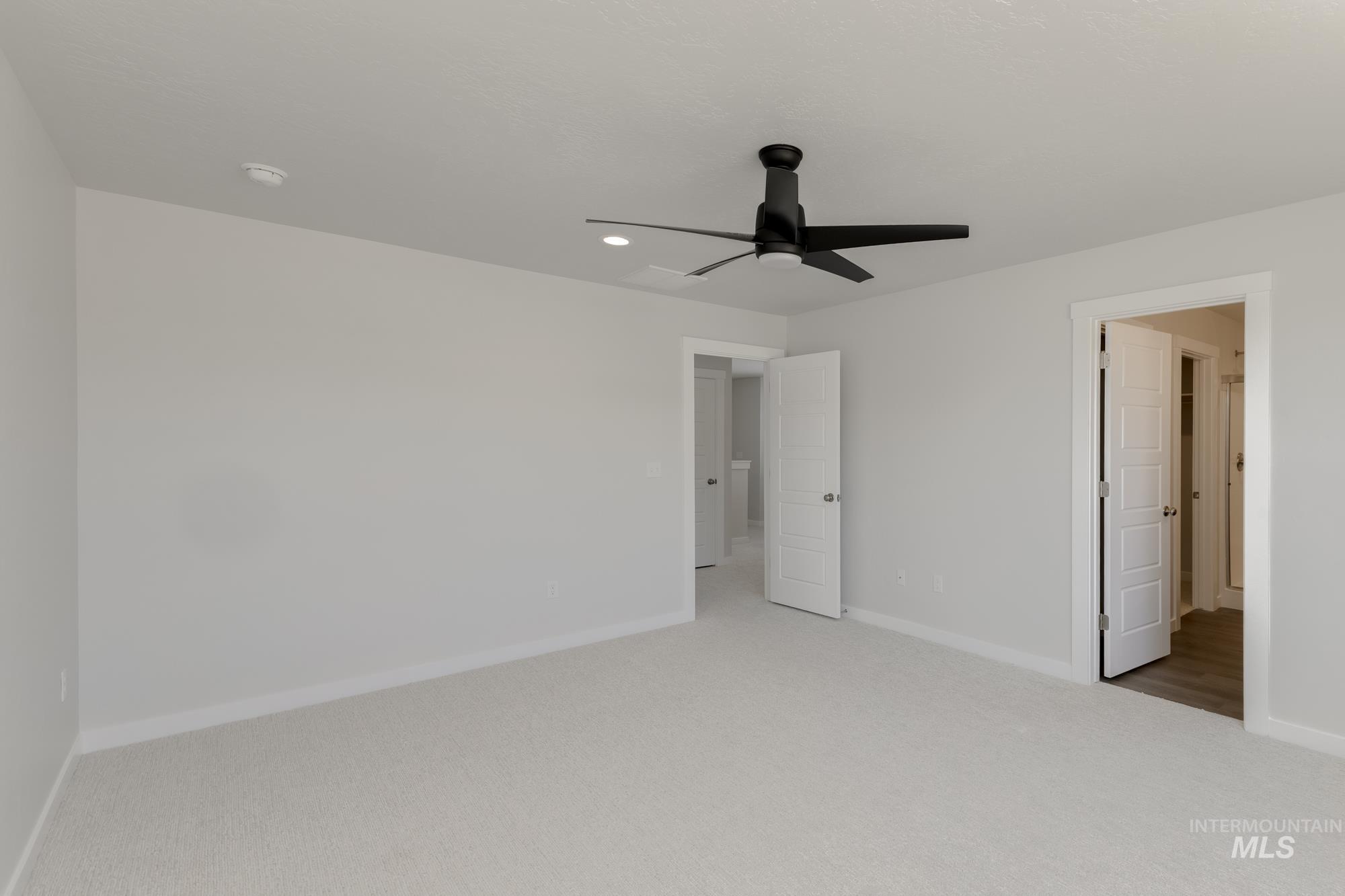 Unfurnished bedroom featuring a ceiling fan, light colored carpet, and recessed lighting