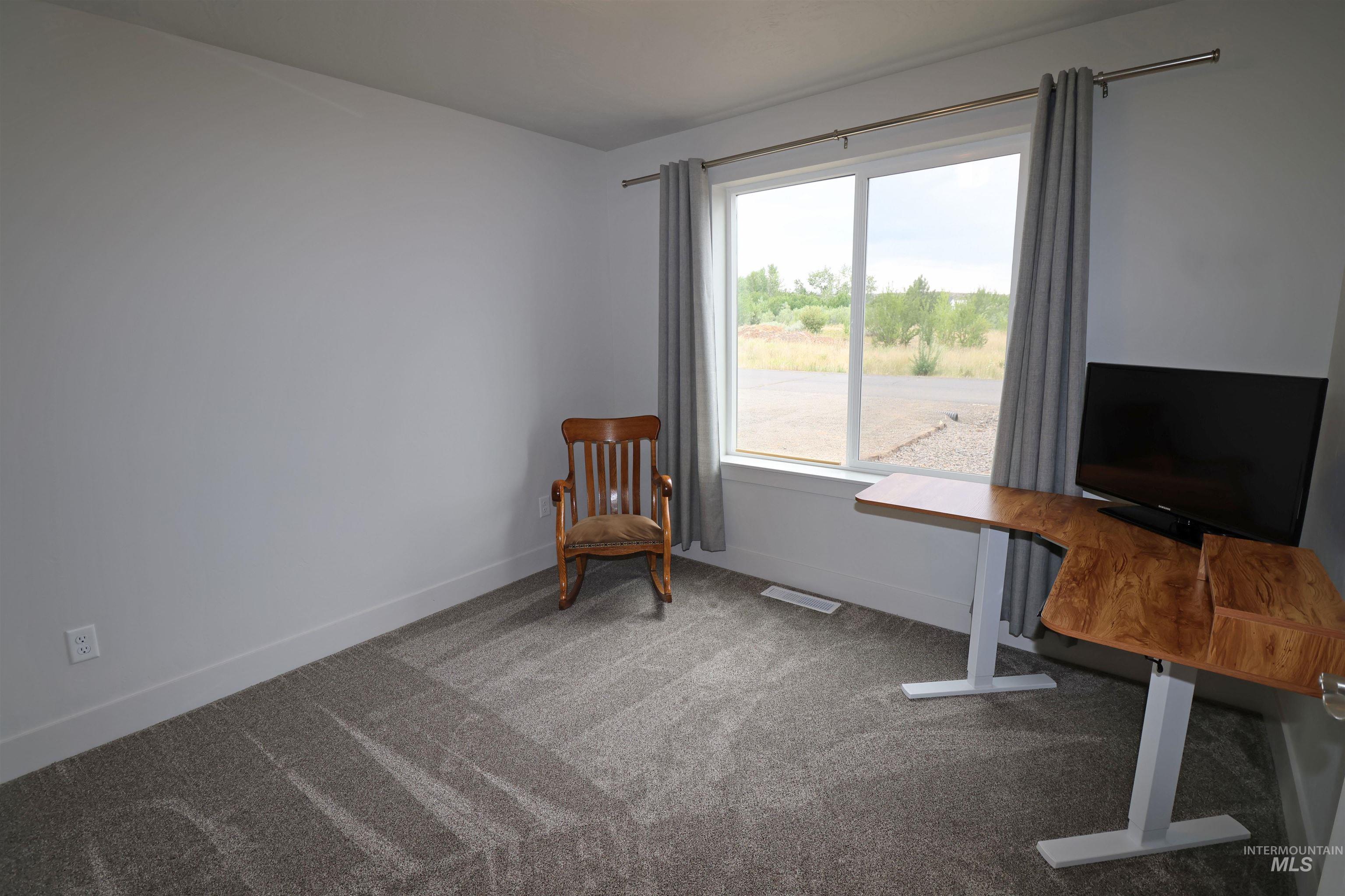 Office area with carpet flooring and baseboards