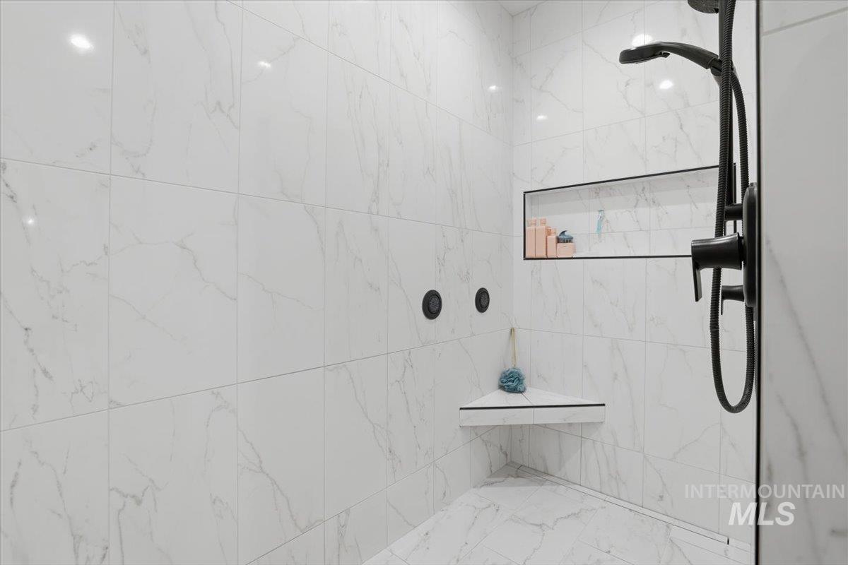 Bathroom with a marble finish shower