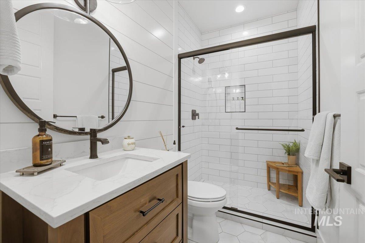 Bathroom featuring vanity and a stall shower