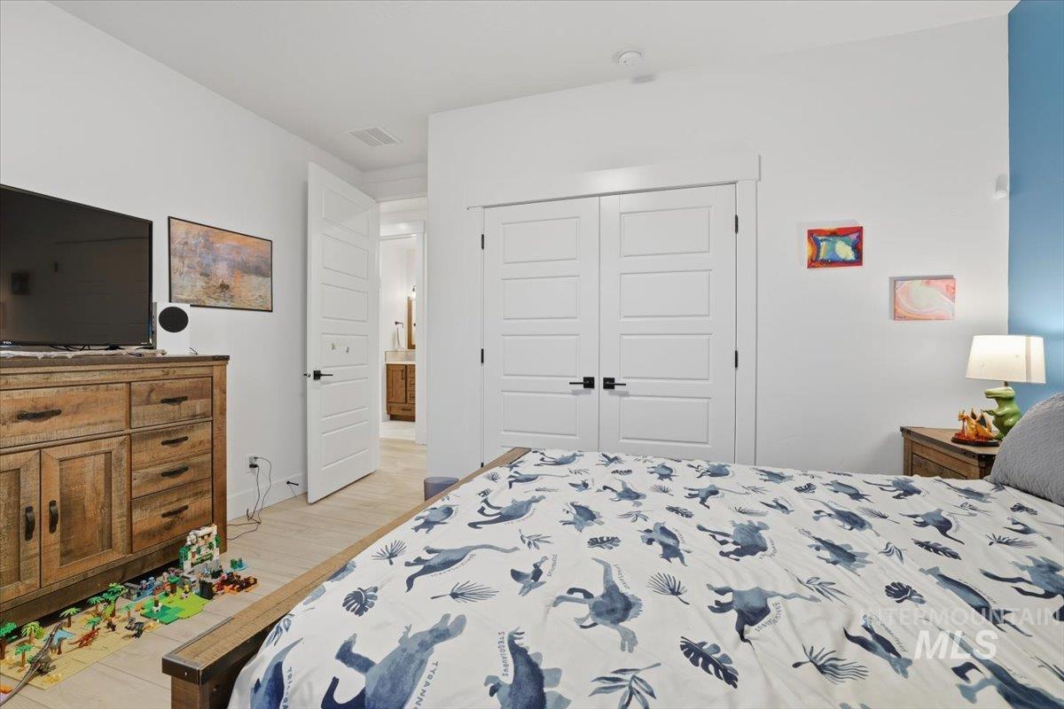 Bedroom featuring a closet and light wood finished floors