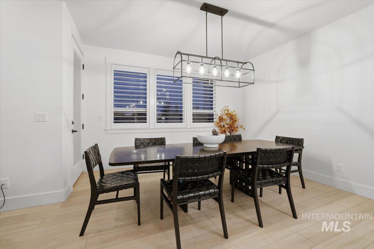 Dining room featuring light wood-style floors and baseboards