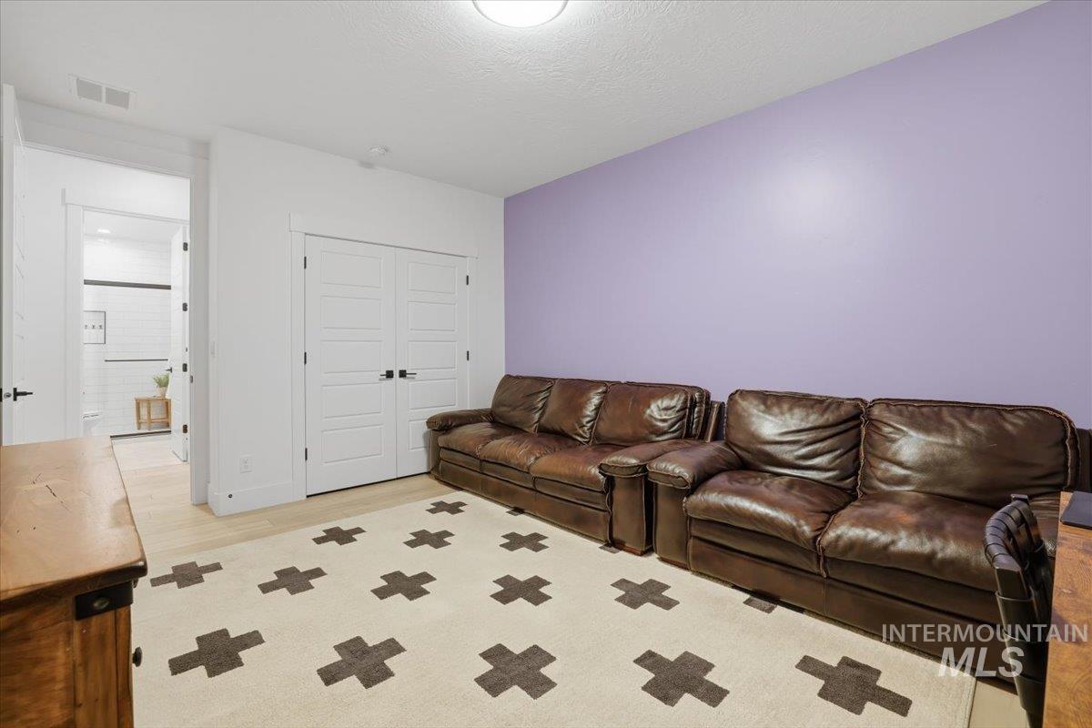 Living area featuring a textured ceiling and light wood finished floors