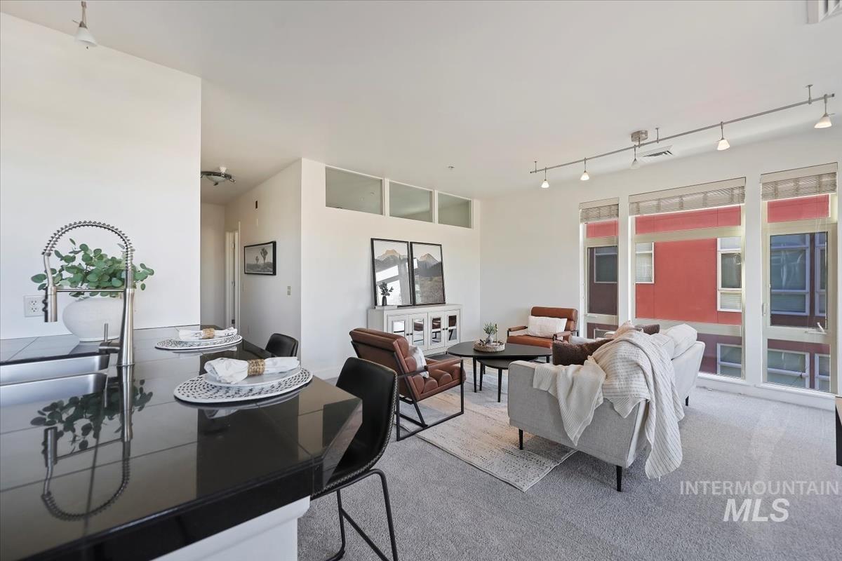 Dining space featuring track lighting and carpet floors