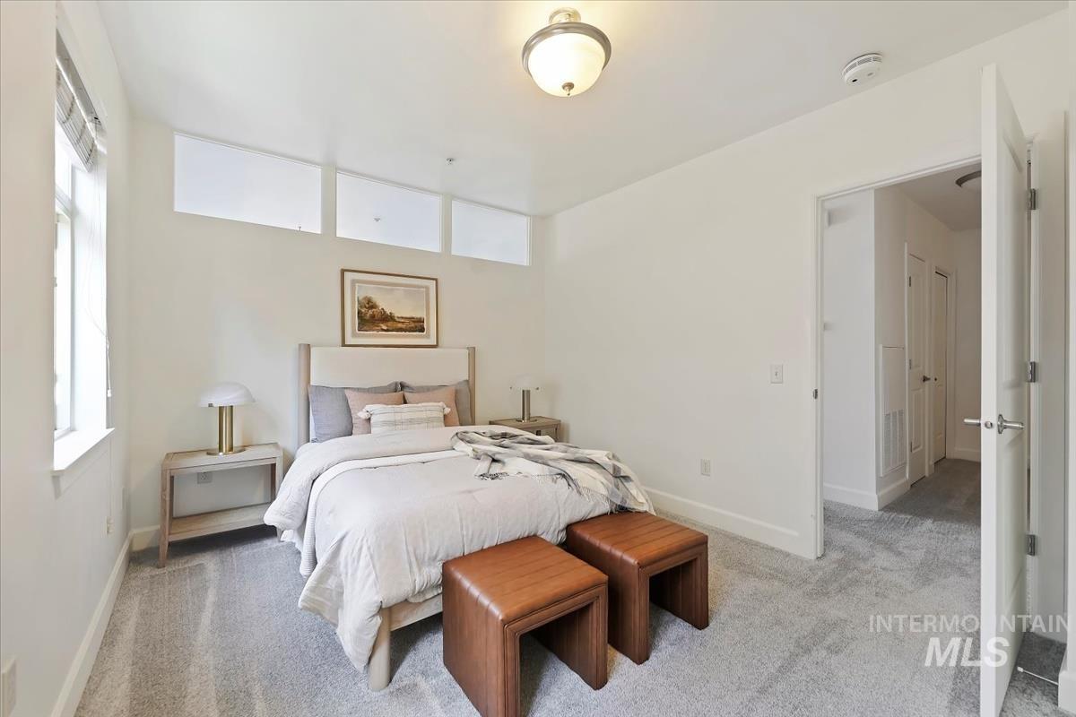 Bedroom featuring carpet and baseboards