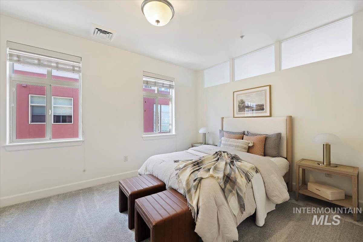 Bedroom featuring carpet floors and baseboards