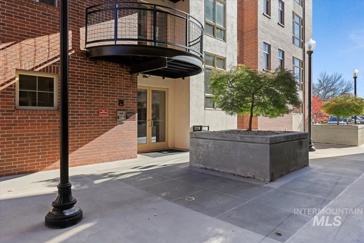 Property entrance featuring brick siding and french doors