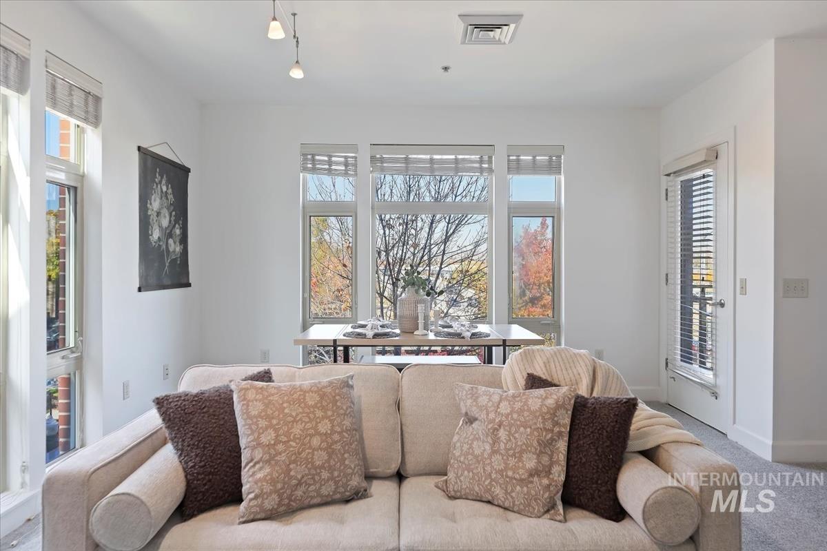 Carpeted living room featuring baseboards