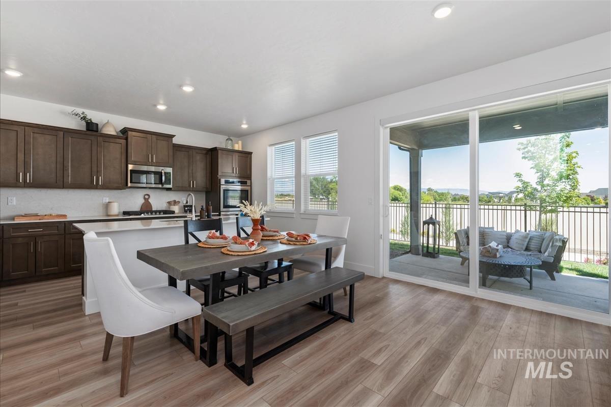 Open-concept living space with wood-finish flooring