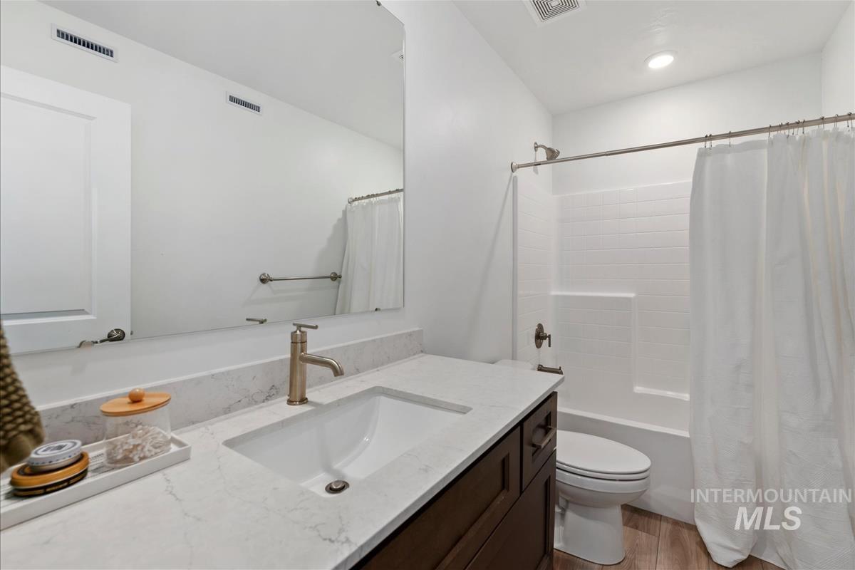Bathroom featuring a white subway tile shower surround, integrated tub, and coordinating white shower curtain