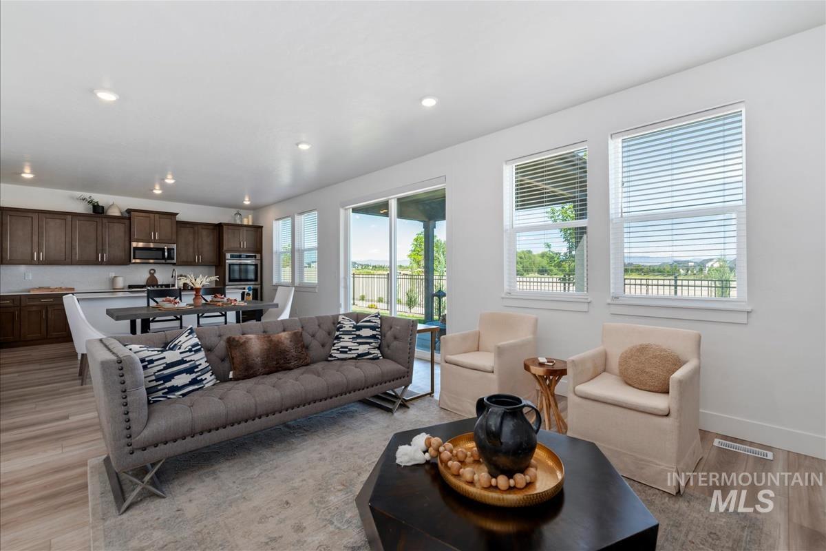Open-concept living space with wood-finish flooring