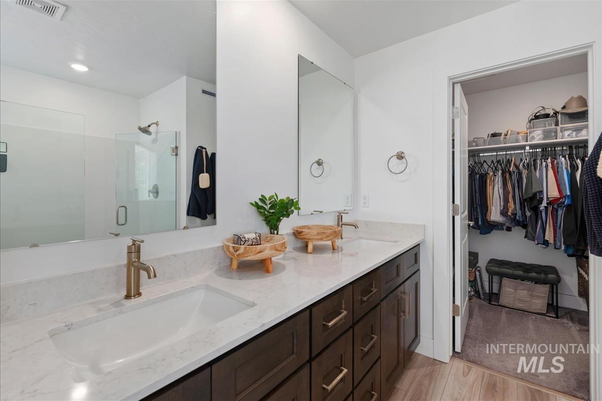 Contemporary bathroom featuring a double vanity with integrated rectangular sinks and gold-finish hardware