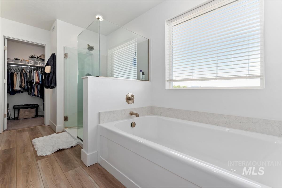 Soaking tub with a light-toned countertop surround and brushed nickel fixtures