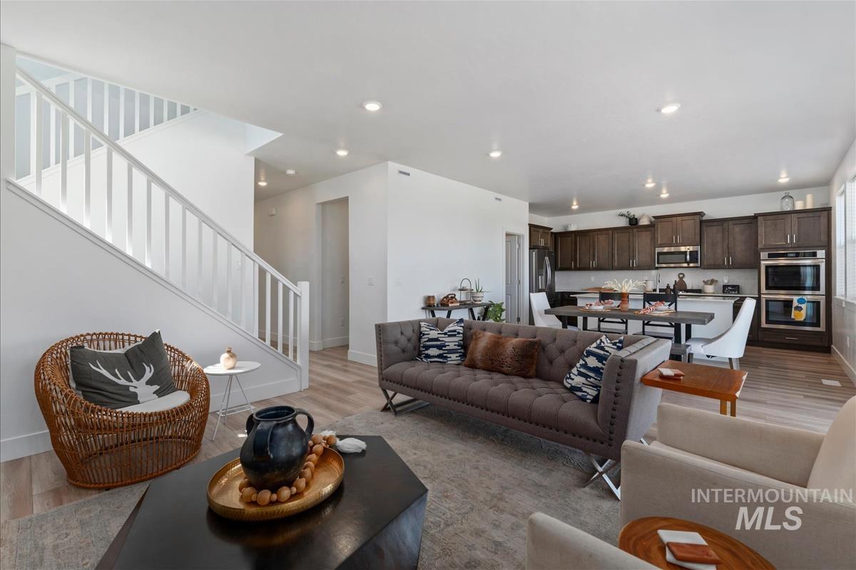 Open-concept living area featuring light wood-finish flooring throughout